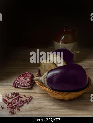 Eggplant and red salad on wooden background Stock Photo