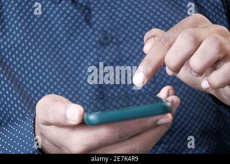 Close up of young man hand using smart phone. Stock Photo