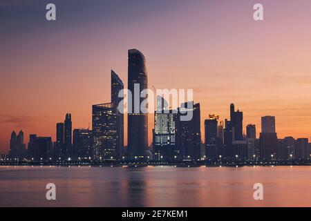 Urban skyline with skyscrapers at beautiful dawn. Cityscape Abu Dhabi, United Arab Emirates. Stock Photo