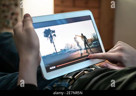 Man watching movie stream. Person using the player timeline to rewind or skip parts of an online video. Bad entertainment or slow internet. Stock Photo