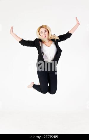 Full length studio photo of a girl isolated on white background. Reference of a positive girl in a jump. Stock Photo