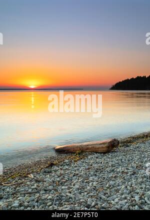 Long exposure shot of the ocean and a driftwood. Corfu Greece Stock Photo