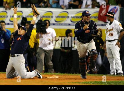 Tigres de Aragua 1B Gimenez and catcher Raul Chavez (L) celebrate after  winning the seventh game of the final series of Venezuela Baseball league  against Leones de Caracas in Caracas, January 30, 2009. Tigres de Aragua  won the final series of the ...