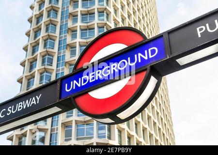 London Underground sign at Tottenham Court Road tube station with Centre Point skyscraper in the background, London, UK Stock Photo