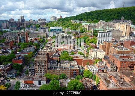 Cloudy Montreal Sky Over Milton Park (McGill Ghetto) with Mount Royal In The Background. Stock Photo