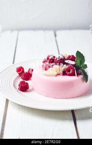 Pink panna cotta dessert with fresh raspberries. Stock Photo