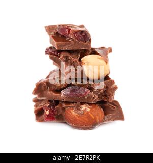 Chocolate pieces stack with nuts and berries, isolated on white background. Close up Stock Photo