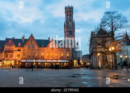 Burg Square at sunset with puddles after the rain. Bell Tower in the background. Bruges, Belgium. Stock Photo