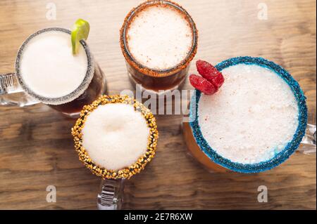 Top view of four different glasses of Mexican beer cocktail on the table Stock Photo