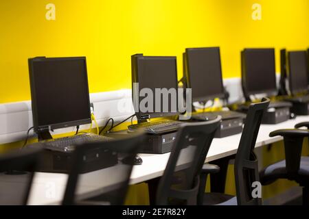 Computer screens lined up in a school classroom Stock Photo - Alamy