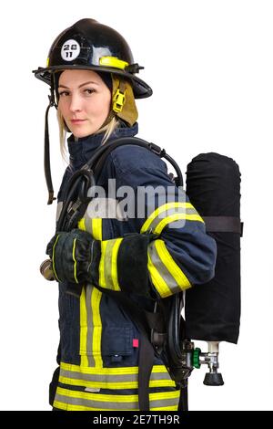 Woman in uniform of firefighter posing in profile with air tank Stock Photo