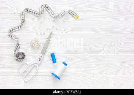 Sewing accessories and sewing supplies. Spools of thread, scissors and centimeter Stock Photo