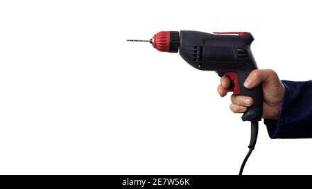 Electric drill in hand isolated on white background, man points with drill. Stock Photo