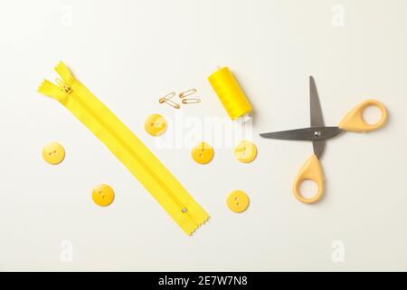 Yellow sewing supplies on white background, top view Stock Photo