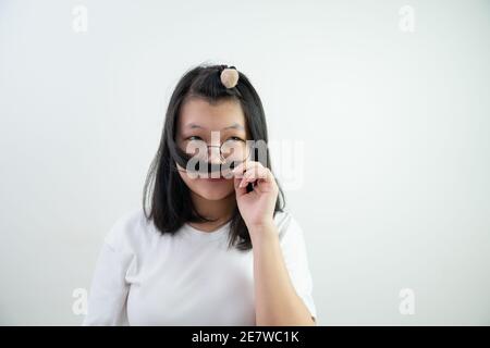 Asian glasses young woman is Thinking something and smelling her hair on on white background. Stock Photo