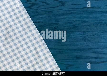 Kitchen towel or napkin over the blue wooden table. Close up. Stock Photo