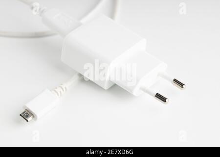 white usb charger for mobile devices on light background Stock Photo