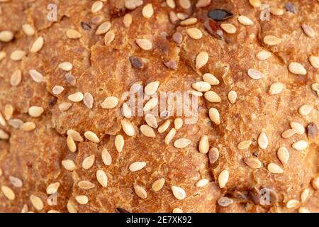 a brown bread with seeds close up macro. background texture Stock Photo
