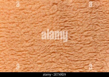 Light brown teddy bear fabric background Stock Photo
