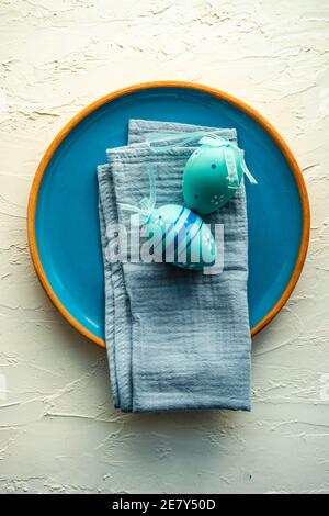 Easter table setting with colored eggs on stone background Stock Photo