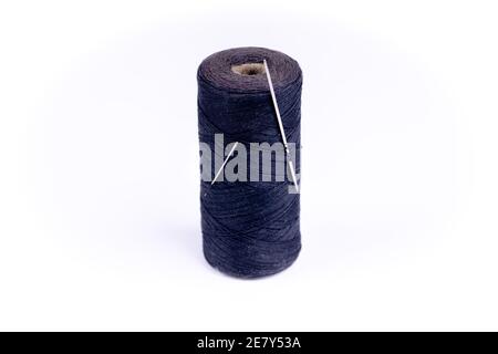 a needle with a thread on a white background Stock Photo