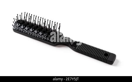 New black hair brush with handle isolated on white background. Combing and hair care, hairdressing tools, haberdashery. Studio shot. Front view. Stock Photo