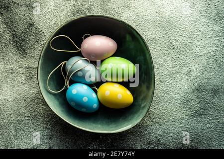 Easter table setting with colored eggs on stone background Stock Photo