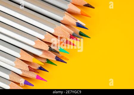 a colored pencils on a yellow background. abstract stationery backdrop Stock Photo