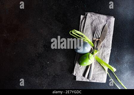 Festive place setting for Easter dinner with eggs on table Stock Photo