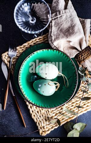 Festive place setting for Easter dinner with eggs on table Stock Photo