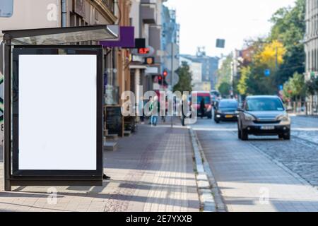 vertical blank white billboard at bus stop on city street, mock-up Stock Photo