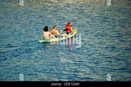 Kreta or Crete, Greece - September 10, 2017: A family of father mother and a son on a kayak during summer holidays vacation. Family floating on a boat Stock Photo