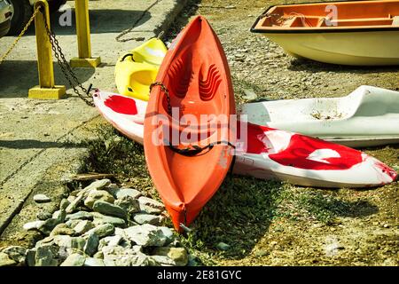 Kreta or Crete, Greece - September 10, 2017: Bunch of colorful kayaks kept on ground under the sun for tourist next to beach. Kayaks or boats for rent Stock Photo