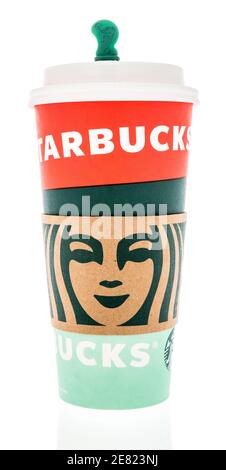 Winneconne, WI -27 January 2021: A cup of Starbucks cup coffee with a Starbucks cardboard cup holder sleeve with Starbucks logo on an isolated backgro Stock Photo