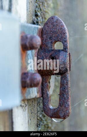 a close up view of a rusted slide lock on the side of a house box Stock ...