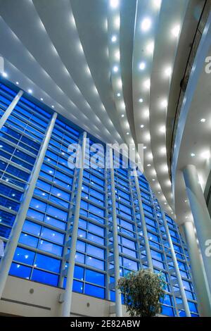 Blue hour through the multistory windows in the lobby of the Sanford and Dolores Ziff Ballet Opera Houseof The Arsht Center for the Performing Arts of Stock Photo