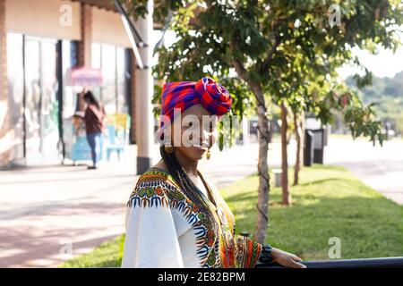 Fashionable black woman in ethnic clothes wearing traditional African style head scarf Stock Photo