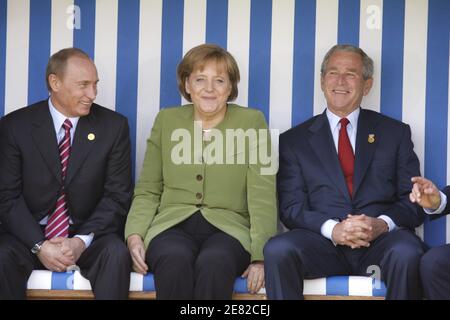 German Chancellor Angela Merkel chats with Russian President Vladimir Putin (L) and US President George W. Bush (R) as they pose in a giant beach chair for a family picture with G8 Heads of States in front of the Kurhaus building in Heiligendamm, northeastern Germany on June 7, 2007. Photo by Ludovic/pool/ABACAPRESS.COM Stock Photo