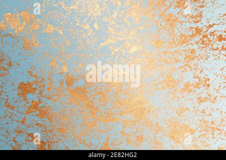 Texture of gold paint on blue paper Stock Photo