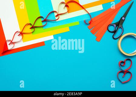 Background for creativity. Colored paper and paper hearts. Cut out of paper. Stock Photo