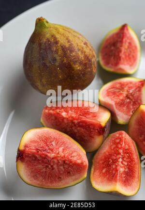 Juicy look sliced ripe figs fruit on white dish Stock Photo