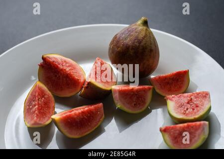 Juicy look sliced ripe figs fruit on white dish Stock Photo