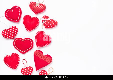 Valentines Day background with red textile hearts on white. Top view, copy space - Image Stock Photo