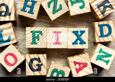Alphabet letter block in word fix with another on wood background Stock Photo