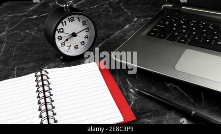 A laptop, clock and notebook on the black rough marble surface. Time management concept. Selective focus Stock Photo
