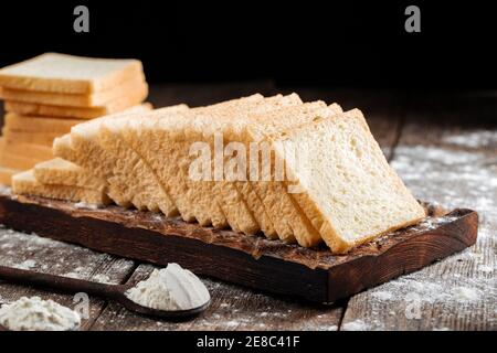 Sliced white sandwich bread on a wooden board Stock Photo