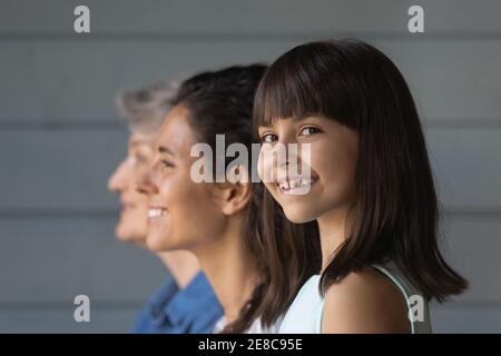Head shot portrait smiling little girl with mother and grandmother Stock Photo
