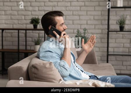 Side view smiling man wearing glasses talking on phone Stock Photo