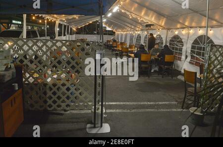 Los Angeles, United States. 31st Jan, 2021. Patrons sit in an outdoor dining area at a Denny's restaurant on Sunset Blvd. in the Hollywood section of Los Angeles on Saturday, January 30, 2021. Los Angeles County lifted it's ban on outdoor dining Friday after a lengthy public health closure. The reopening comes with new COVID-19 rules including, TVs off with six people or fewer per table and from the same family, and each table eight feet apart. Photo by Jim Ruymen/UPI. Credit: UPI/Alamy Live News Stock Photo