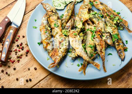 Fried capelin fish with herbs and lemon zest Stock Photo